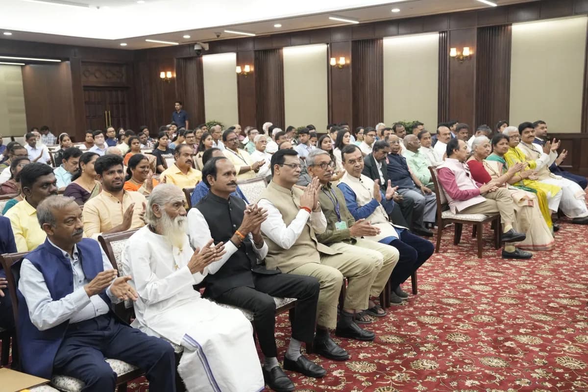Seated audience applauding at the book release event